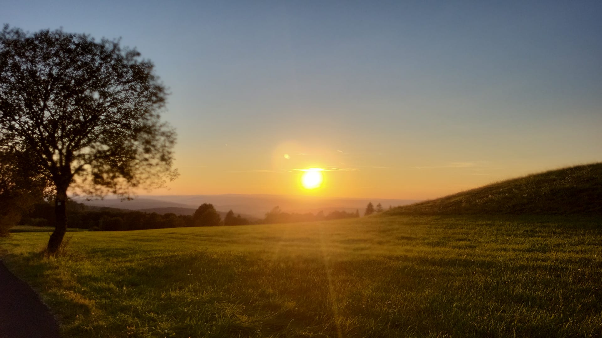 Sunset over green hills
