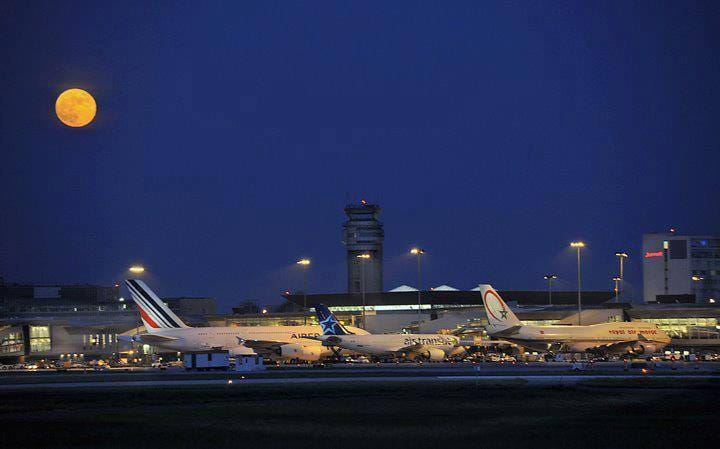 Moon above an airport at night