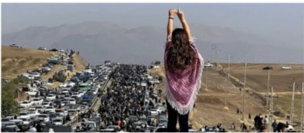 A person raises their hands above a crowded road