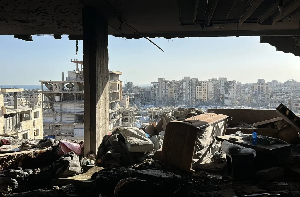 View from inside a damaged home across ruined buildings in Gaza City