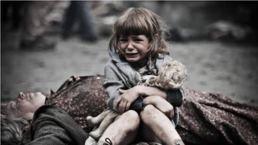 A distressed child holding a toy beside an adult lying on the ground