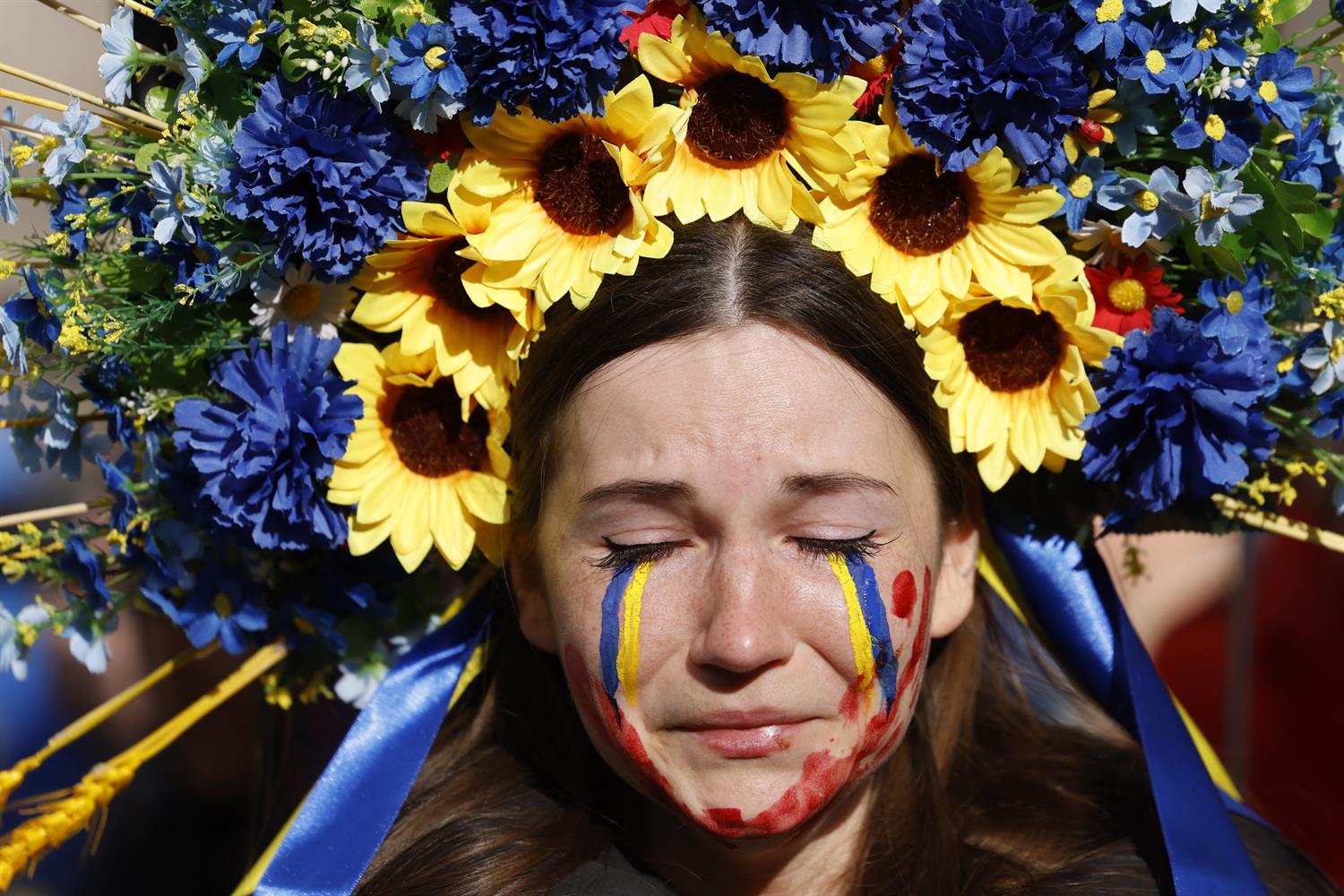 A woman wearing a blue and yellow flower wreath